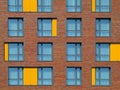 Abstract brown and yellow brick facade with windows Royalty Free Stock Photo