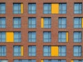 Abstract brown and yellow brick facade with windows Royalty Free Stock Photo