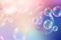 Abstract bubbles background. Realistic transparent colorful soap bubbles with rainbow reflection on a light purple background. Royalty Free Stock Photo