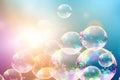 Abstract bubbles background. Realistic transparent colorful soap bubbles with rainbow reflection on a trendy colored background. Royalty Free Stock Photo