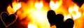 Abstract burning hearts, bright flamy symbol on the black background Royalty Free Stock Photo