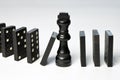 Abstract business concept with King chess piece and domino pieces fallen Royalty Free Stock Photo