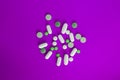 Abstract capsule and pills on neon ultraviolet backdrop