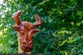 Abstract carved rustic decorative head of a bull or bison. Wood carving is popular hobby in the culture