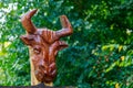 Abstract carved rustic decorative head of a bull or bison. Wood carving is popular hobby in the culture