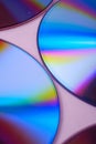 Abstract CD DVD compact disc disk dispersion refraction reflection of light colors texture on pink background close up Royalty Free Stock Photo