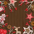 Abstract christmas background, dry branches with red berries and small scandinavian styled decorations lying on wooden Royalty Free Stock Photo