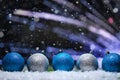 Abstract Christmas background,New Year and Christmas background. Blue and white Christmas toys lie on the snow, with a bright Royalty Free Stock Photo