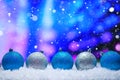 Abstract Christmas background,New Year and Christmas background. Blue and white Christmas toys lie on the snow, with a bright Royalty Free Stock Photo