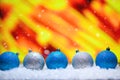 Abstract Christmas background,New Year and Christmas background. Blue and white Christmas toys lie on the snow, with a bright Royalty Free Stock Photo