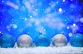 Abstract Christmas background,New Year and Christmas background. Blue and white Christmas toys lie on the snow, with a bright Royalty Free Stock Photo