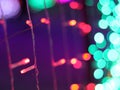 Abstract Christmas Bokeh light blurred background, lightbulb on Christmas tree for celebrate season with red, green and colorful Royalty Free Stock Photo
