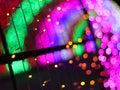 Abstract Christmas Bokeh rainbow blurred background, lightbulb on Christmas tunnel lights for celebrate season with red, green. Royalty Free Stock Photo