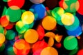 Abstract Christmas and carnival background with colorful bokeh lights of garland, red, green, blue, yellow colors of New Year with Royalty Free Stock Photo