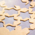 Abstract Christmas food background with cookies molds and flour. Baking Christmas cookies - table, cookie cutters and cookies.