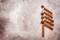 Abstract Christmas tree made of cinnamon sticks and spices. Beige grunge background. Top view, flat lay Royalty Free Stock Photo