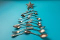 Abstract Christmas tree made from blue background. Top view . tree of knives and forks with a star Royalty Free Stock Photo