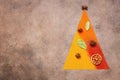 Abstract christmas tree made of spices on dark rustic background. Holiday concept. View from above