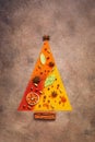 Abstract christmas tree made of various spices on dark rustic background. Holiday concept. View from above