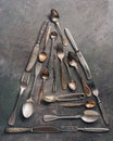 Abstract christmas tree from old vintage cutlery on a dark rustic background. Top view, flat lay. Christmas and new year concept Royalty Free Stock Photo