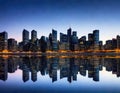 Abstract city skyline at night a panorama of multiple buildings which are tall and modern with a lot of lit glass Blue and Royalty Free Stock Photo
