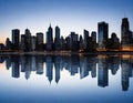 Abstract city skyline at night a panorama of multiple buildings which are tall and modern with a lot of lit glass Blue and Royalty Free Stock Photo