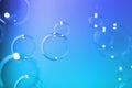 Abstract, Clear transparent bubbles float on dark blue texture background. Royalty Free Stock Photo