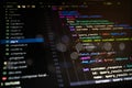 Abstract close-up of colorful programming code on dark screen, representing software development, digital systems, data processing Royalty Free Stock Photo