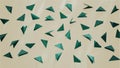 Abstract close up of 3D paper tidewater green triangles folded in geometric shapes on trend set sail champagne backdrop