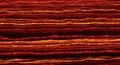 Abstract close up of layered red and orange threads creating a textured wavy pattern Royalty Free Stock Photo