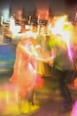 Abstract close up motion blur colourful image of happy dancing people in a disco night club. Royalty Free Stock Photo