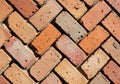 Close-up view of rustic red bricks laid in a detailed herringbone pattern texture Royalty Free Stock Photo