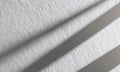 Abstract close-up of textured white wall with soft shadows creating an artistic interplay of light and dark Royalty Free Stock Photo