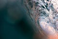 Abstract, close up water shot of the inside of a breaking, barrelling wave as golden sunset light filters through Royalty Free Stock Photo