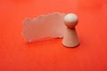 Abstract closeup macro shot of a wooden pawn next to a torn cardboard