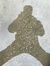 Nice closeup abstract view  of a human person shadow figure shape on asphalt surface, road  background Royalty Free Stock Photo