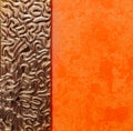 Abstract closeup view of interior orange painted wall with fragment of mirror decorated metal frame