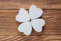 Abstract clover on wood background, top view, flat lay. Abstract white wooden clover