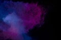 Abstract colored dust explosion on a black background.abstract powder splatted background,Freeze motion of color powder exploding/ Royalty Free Stock Photo