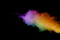 Abstract colored dust explosion on a black background.abstract powder splatted background,Freeze motion of color powder exploding/ Royalty Free Stock Photo