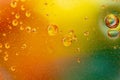 Abstract colorful background with oil drops and waves on water surface Royalty Free Stock Photo