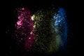 Abstract colorful dust particles textured background.Multicolored powder explosion on black background Royalty Free Stock Photo