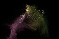 Abstract colorful dust particles textured background.Multicolored powder explosion on black background Royalty Free Stock Photo