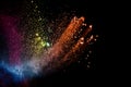 Abstract colorful dust particles textured background.Multicolored powder explosion on black background Royalty Free Stock Photo