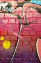 Abstract colorful fragment of graffiti paintings on old brick wall. Street art composition with parts of unwritten letters and