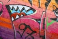 Abstract colorful fragment of graffiti paintings on old brick wall. Street art composition with parts of unwritten letters and