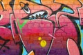 Abstract colorful fragment of graffiti paintings on old brick wall. Street art composition with parts of unwritten letters and