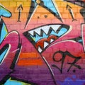 Abstract colorful fragment of graffiti paintings on old brick wall. Street-art composition with parts of wild letters and