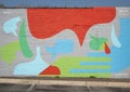 Abstract colorful mural painted on an outside brick wall of a business in the Plaza District, Oklahoma City.