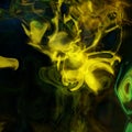 Abstract colorful neon smoke swirls in yellow and green on black background Royalty Free Stock Photo